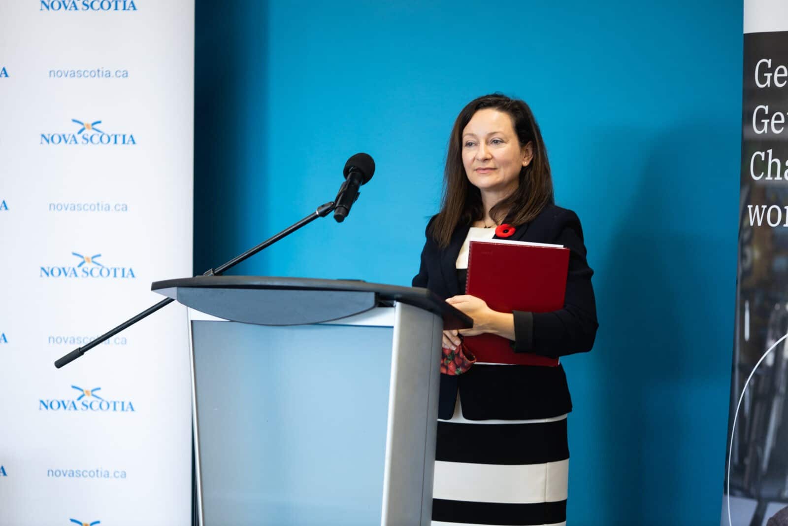 Image of Diana Parks, Halifax’s regional director for NPower Canada, speaking at a podium in a Nova Scotia government conference room